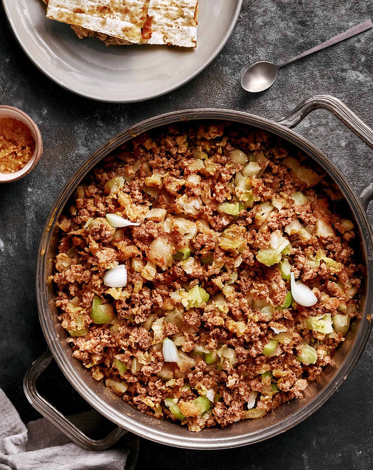 Matzo stuffing with ShopGalil matzos, onions, herbs, and broth, baked until golden and flavorful for a Passover side dish.